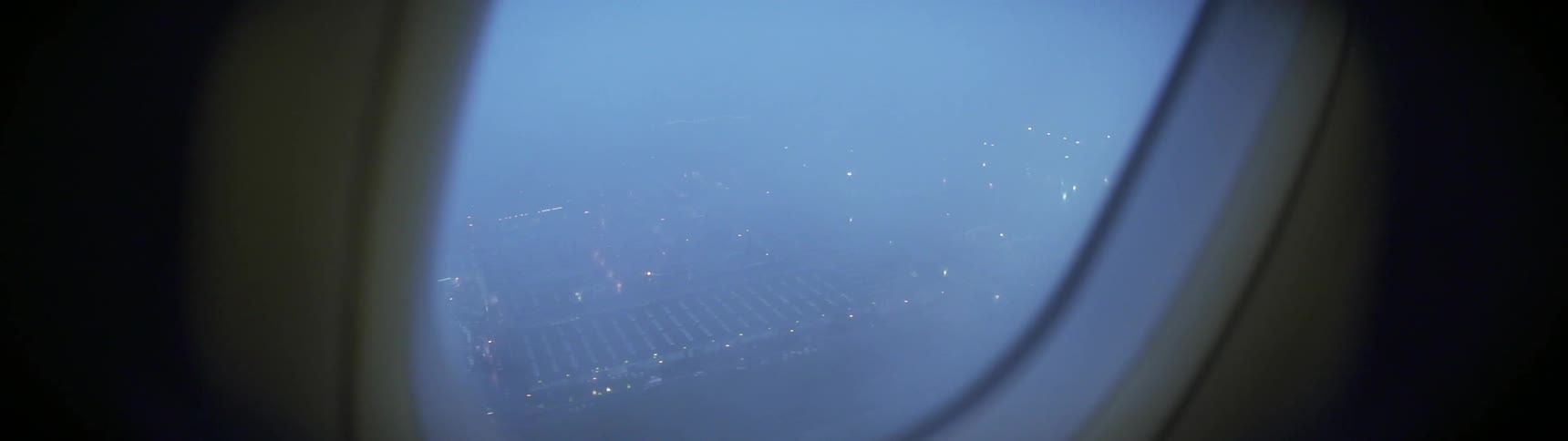 An airplane flies over an airport
