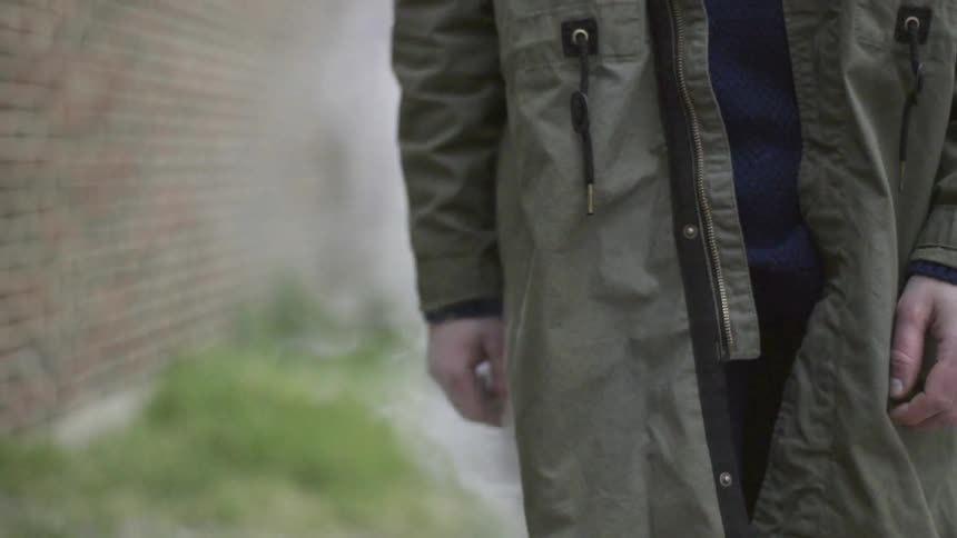 A man has smoke coming out of his jacket