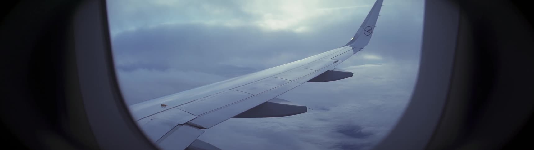 Looking out the window of a flying airplane at the wing