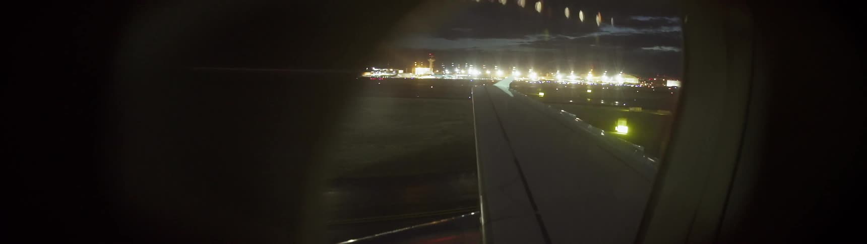 The plane slowly moves on the dark runway