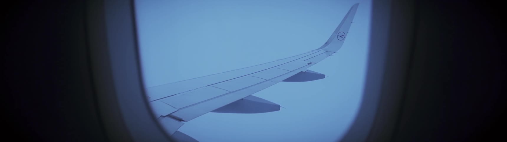 A plane's wing seen while flying and seen from a passenger's window