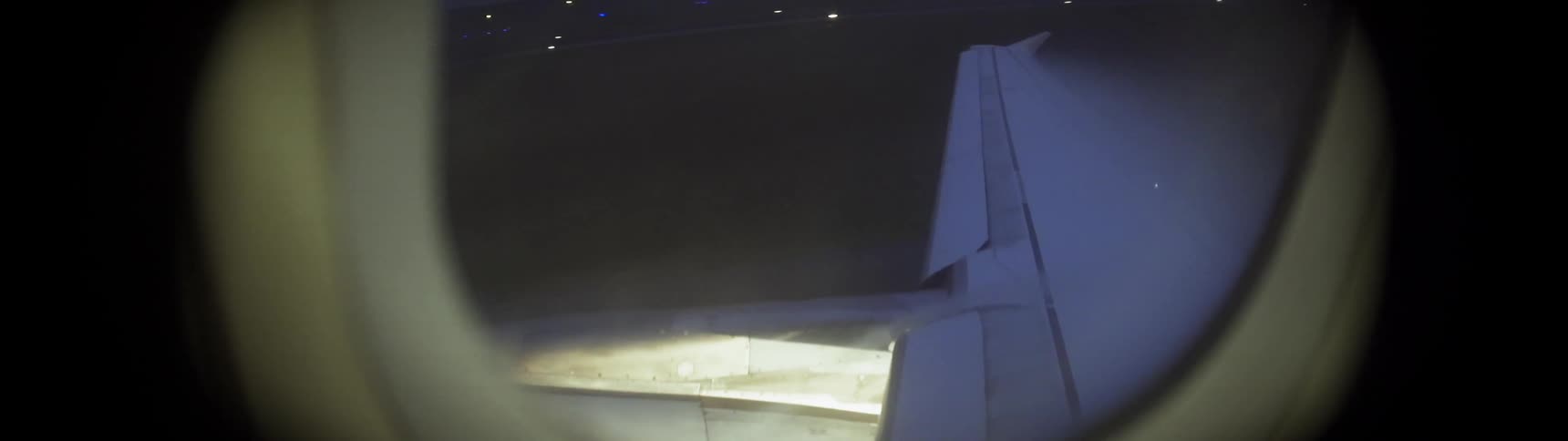 Airplane moving on airport grounds at night