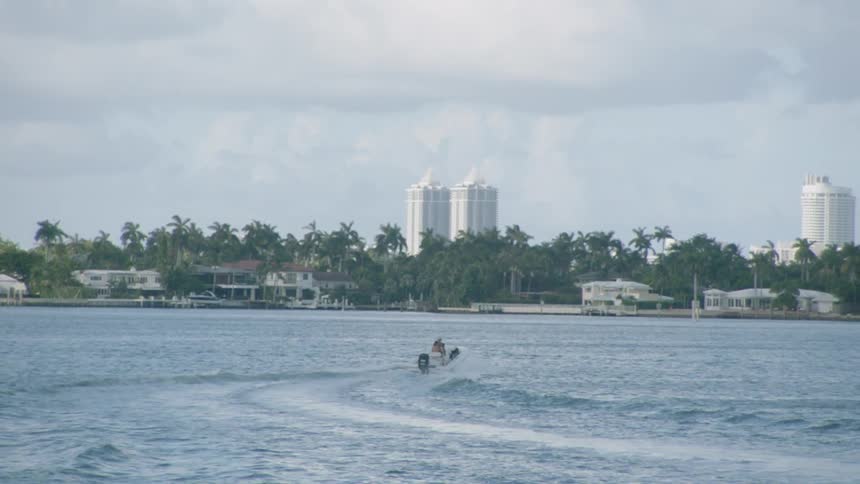 A motorboat leaves a wake as it heads for shore