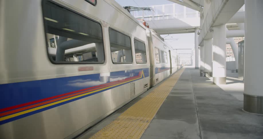 Train departs from a station on a sunny day