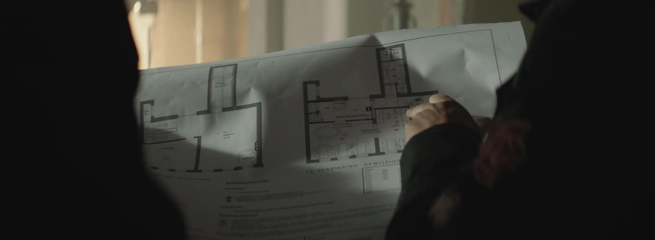 Two people look at building plans