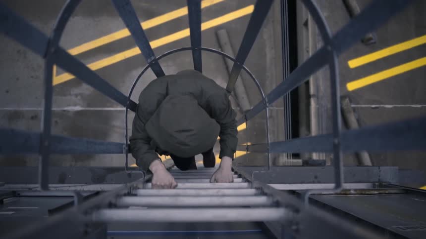 Man climbing down a tall ladder