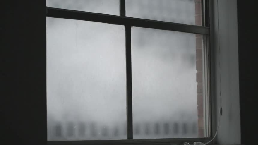 Smoke drifting past a window