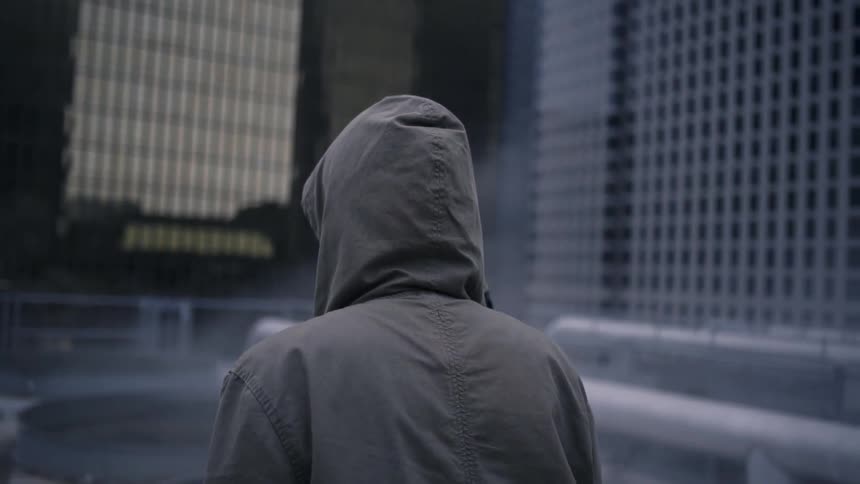 Smoke billows around a man with a jacket