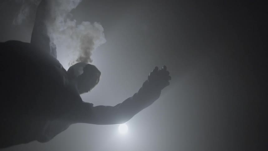Smoke coming out of a man's sweater