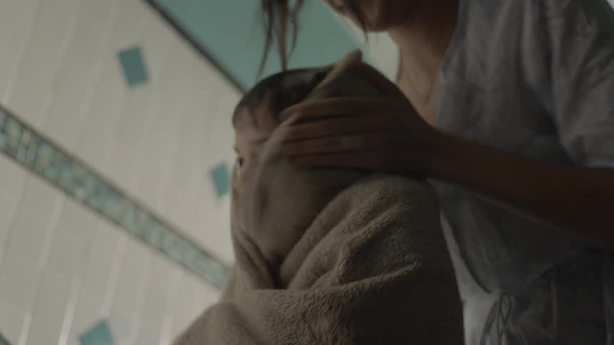 A person drying off a child