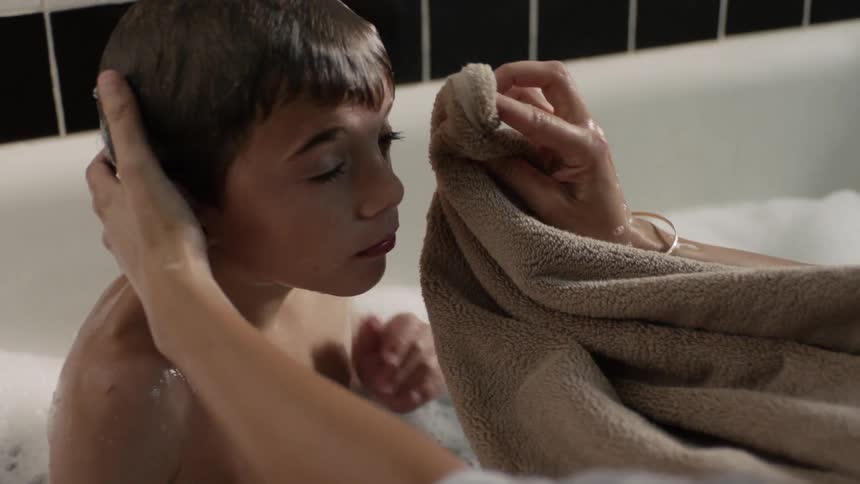 Child being washed in a bathtub