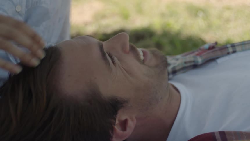 A person running their hand thru someones hair
