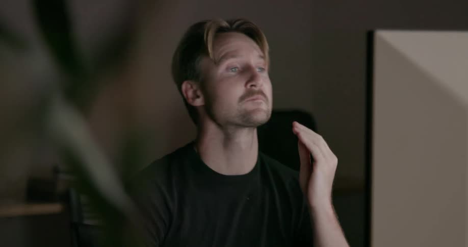 Man rubs face with hands