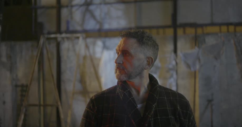 Man stands in warehouse and looks over his shoulder