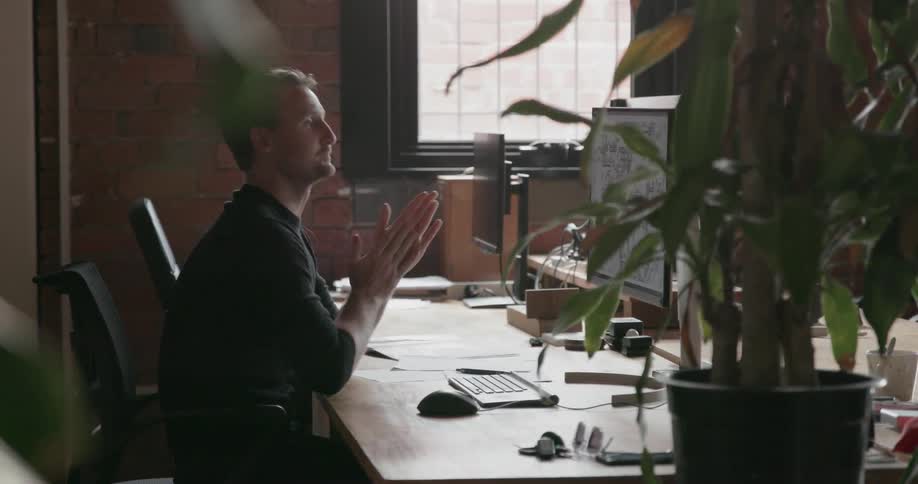 Man works on a computer in an office