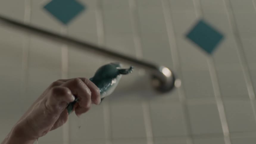 A boy is playing with toys in the bathtub