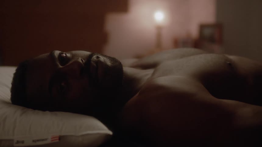 Man laying on bed is staring off