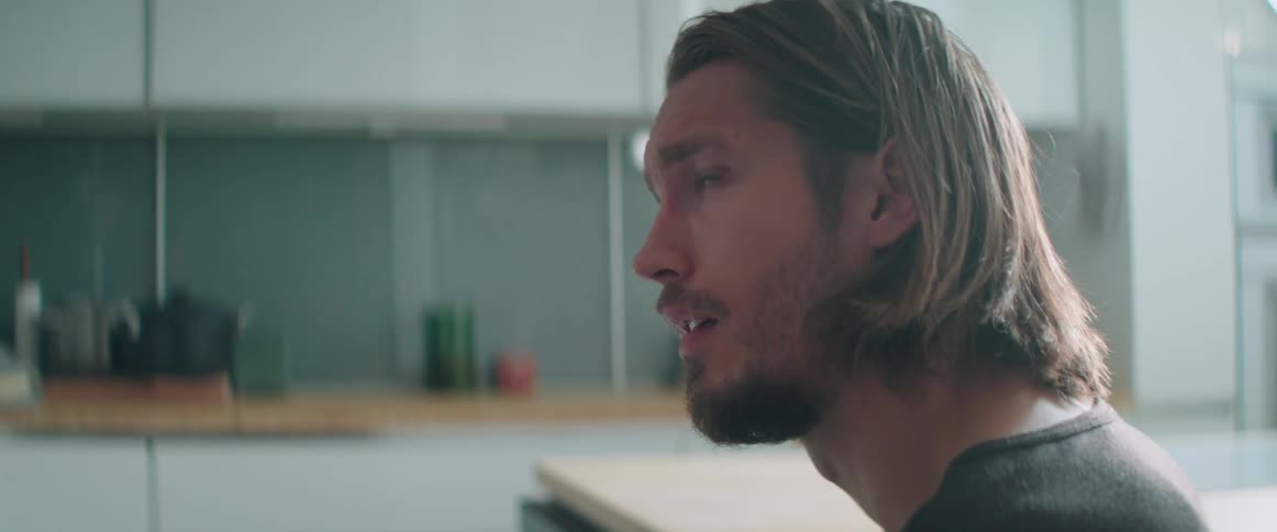 Close up of a concerned male character speaking during an argument at home.