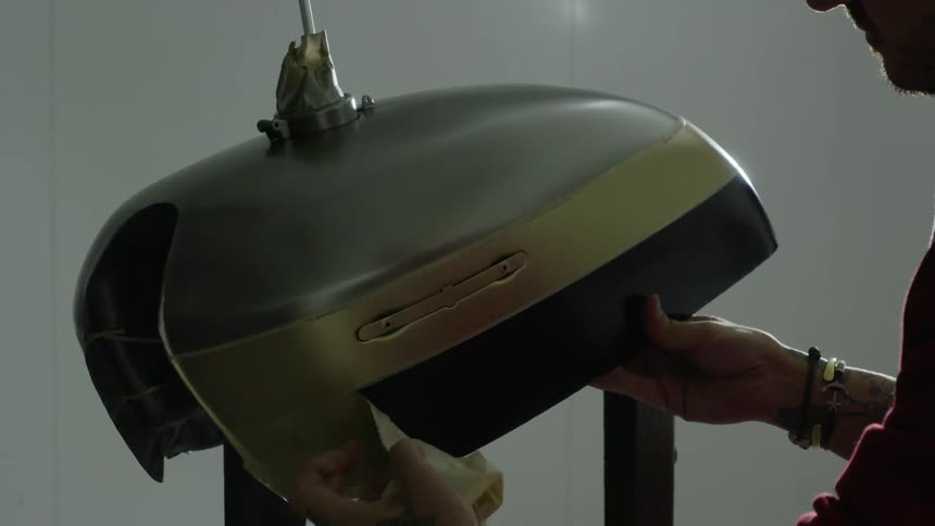 Man removes tape from a motor tank