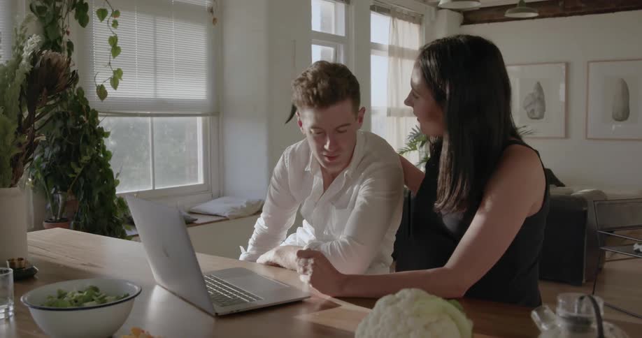 A man and woman talk at home