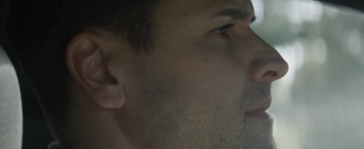 A man looks straight ahead as he drives