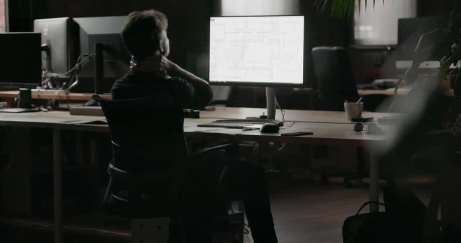 Man sits at a desk working at night