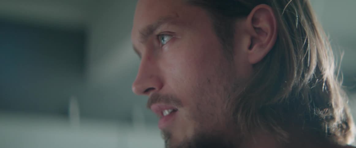 Close up of a frustrated male character talking during an intense indoor dispute.