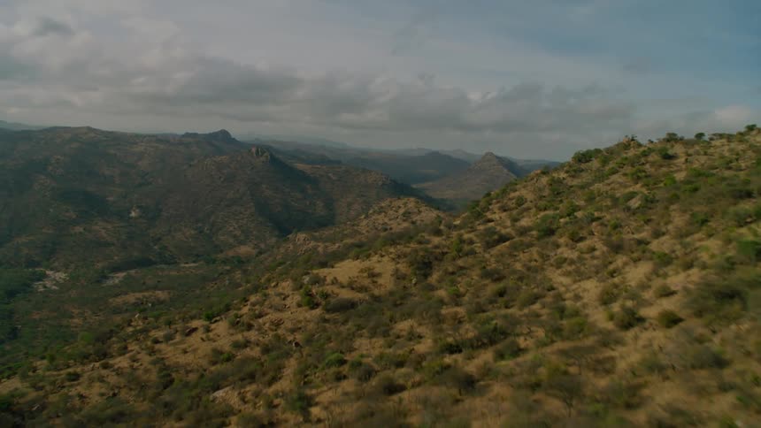 The long mountain range is covered with green