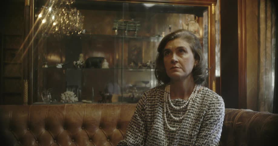 A woman sits on a sofa