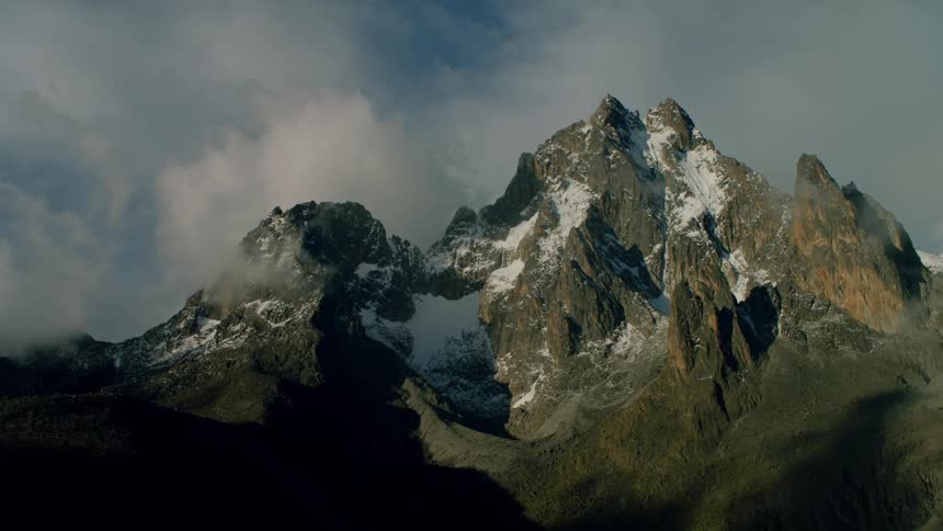 Clouds lingering near mountaintops on an overcast day