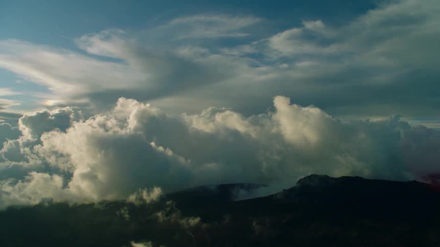 The heavy clouds sit right on top of the mountains ahead