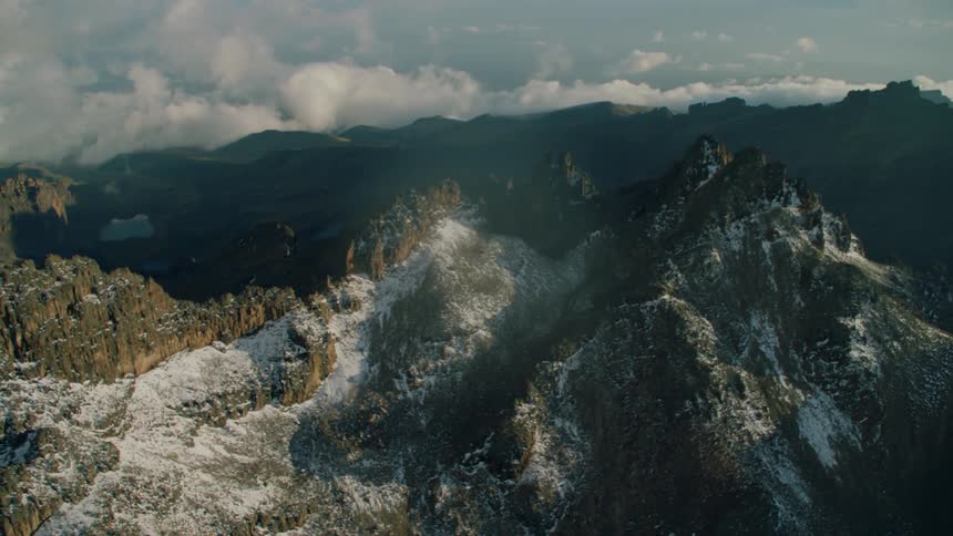 Snow covered mountains under a cloudy sky