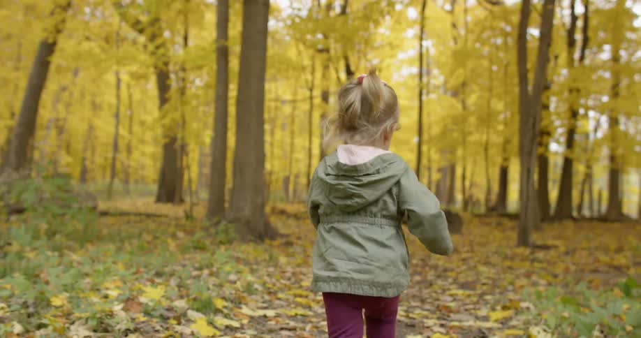 Little girl runs in the forest