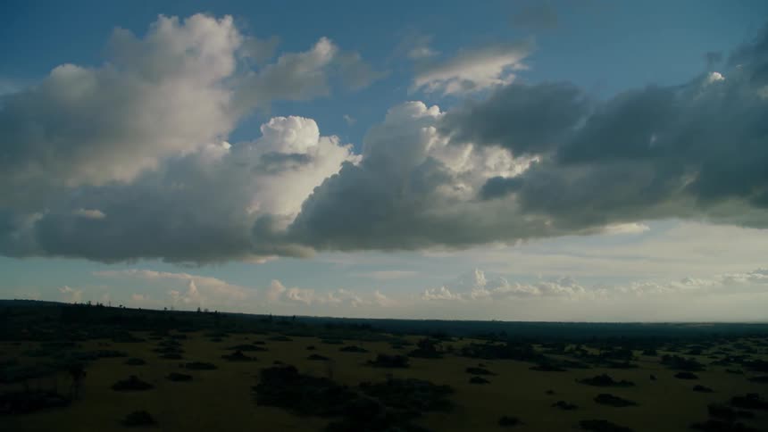 Clouds are drifting over a remote landscape in daylight