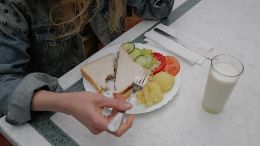 A woman plays with her food
