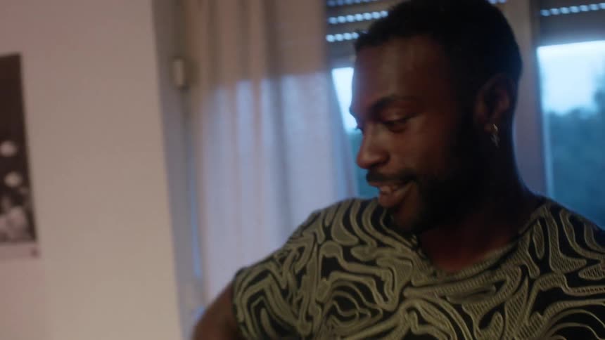 Two men are smiling and dancing i the living room