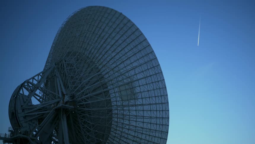 A large satellite is tilted towards the sky