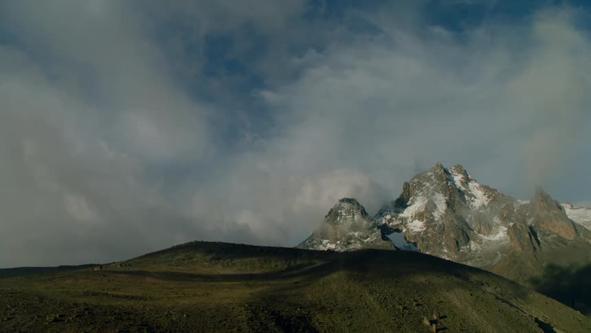 Clouds lingering near mountaintops on an overcast day