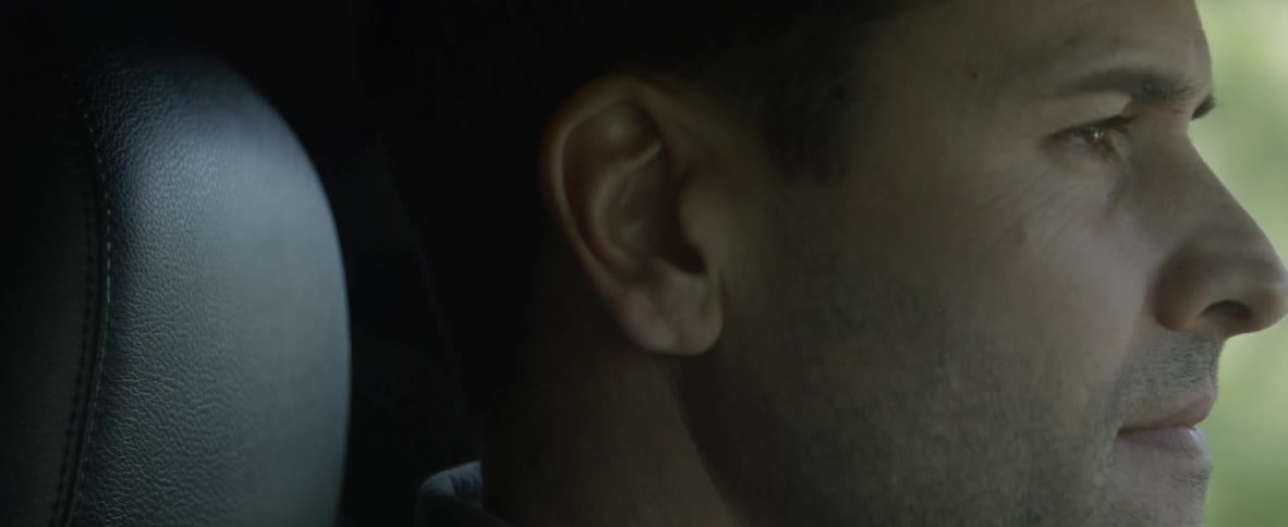 Close up of a mans face as he is driving
