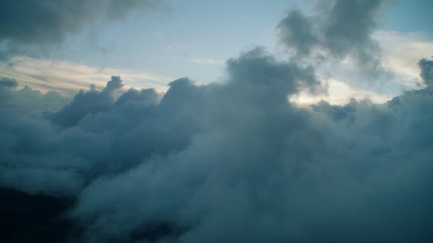 Clouds form under a blue sky
