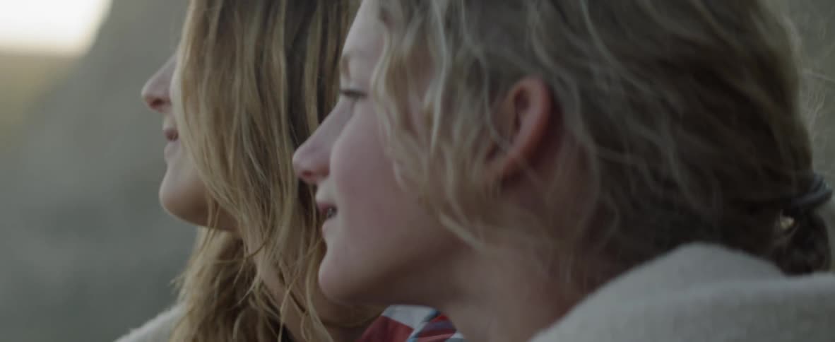 A parent and daughter are sitting and talking together