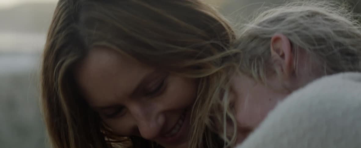 A mom and daughter are hugging