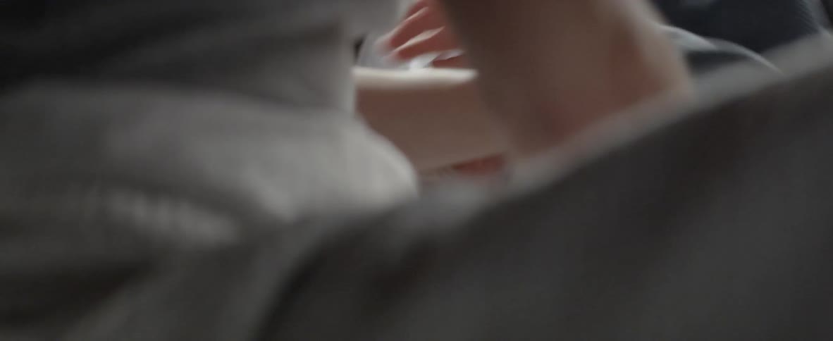 Adult tickles a child laying in bed