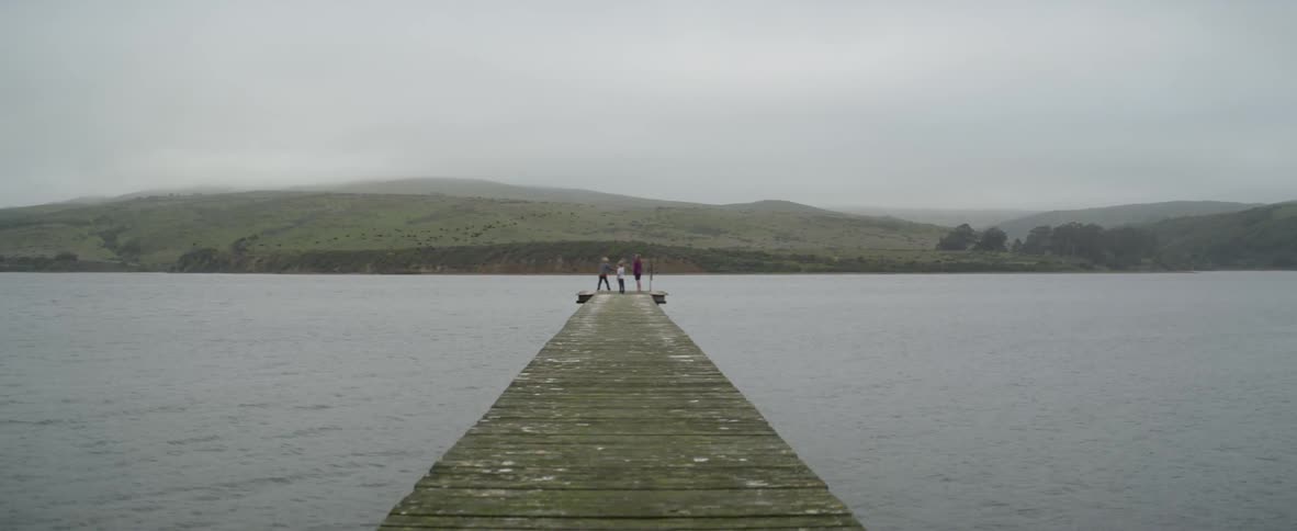 People are standing at the end of the pier