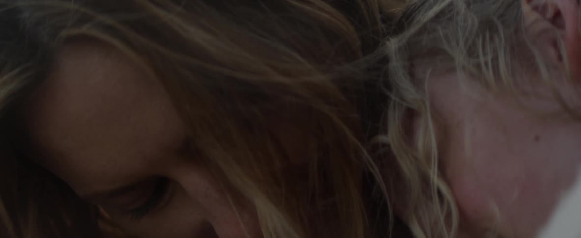 Woman's face looks down and up and smiles