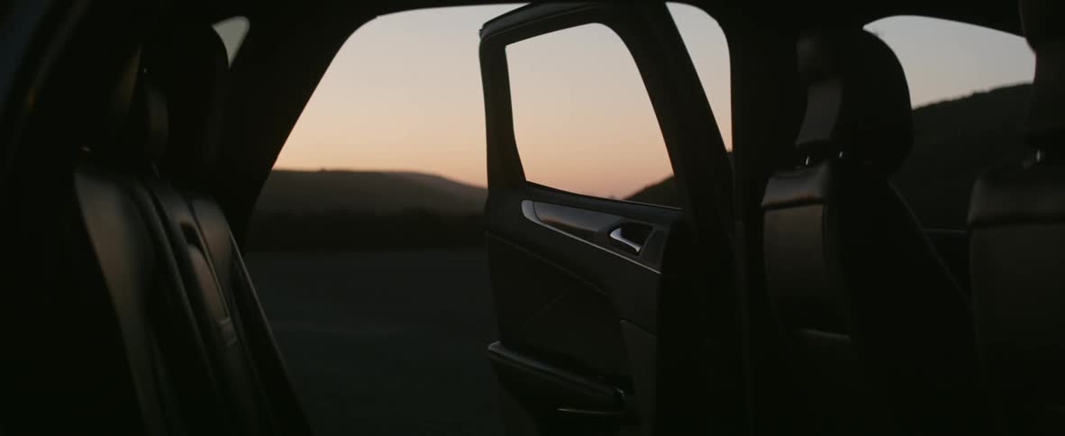 Door open on parked car at sunset