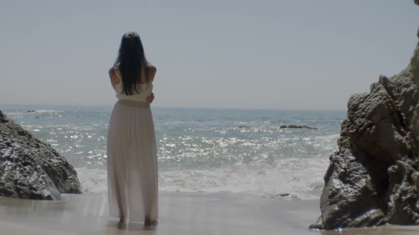 A woman is watching the waves