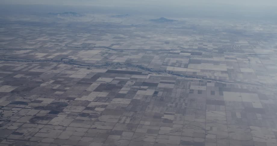 The fields below are brown and covered with fog