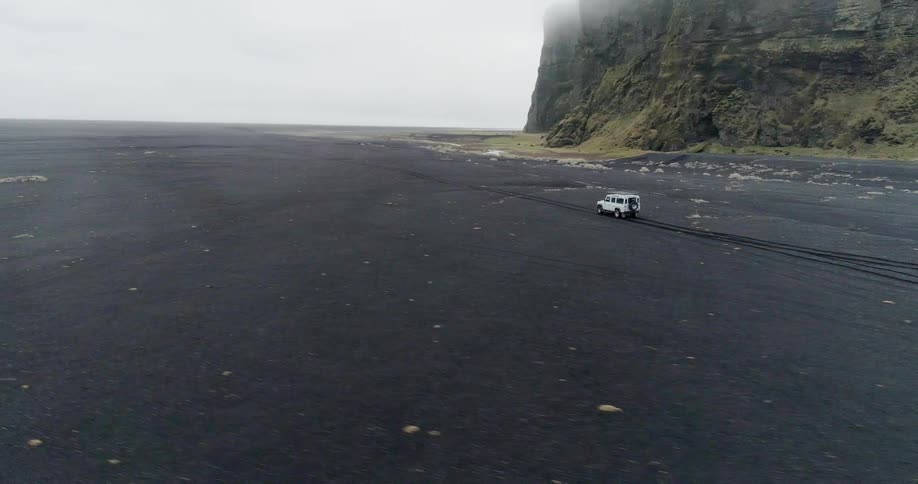 A vehicle drives near a cliff