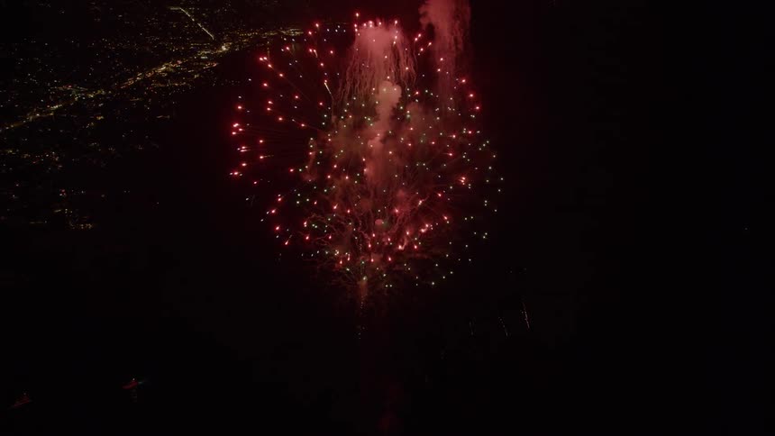 Fireworks burst in the sky over the harbor and city